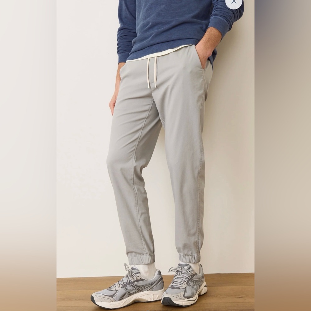 Marine Layer Saturday Joggers in a faded olive or sage green color.
